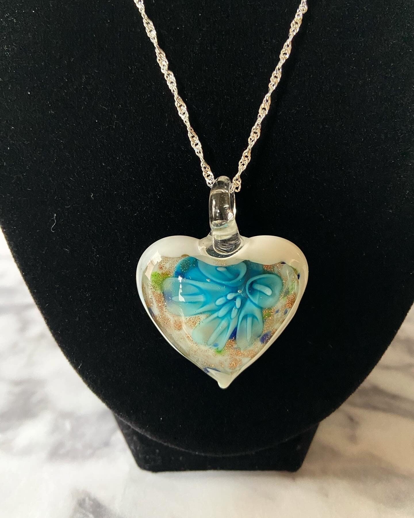 Large light blue calla lily floral with gold glitter on white Murano style heart glass necklace