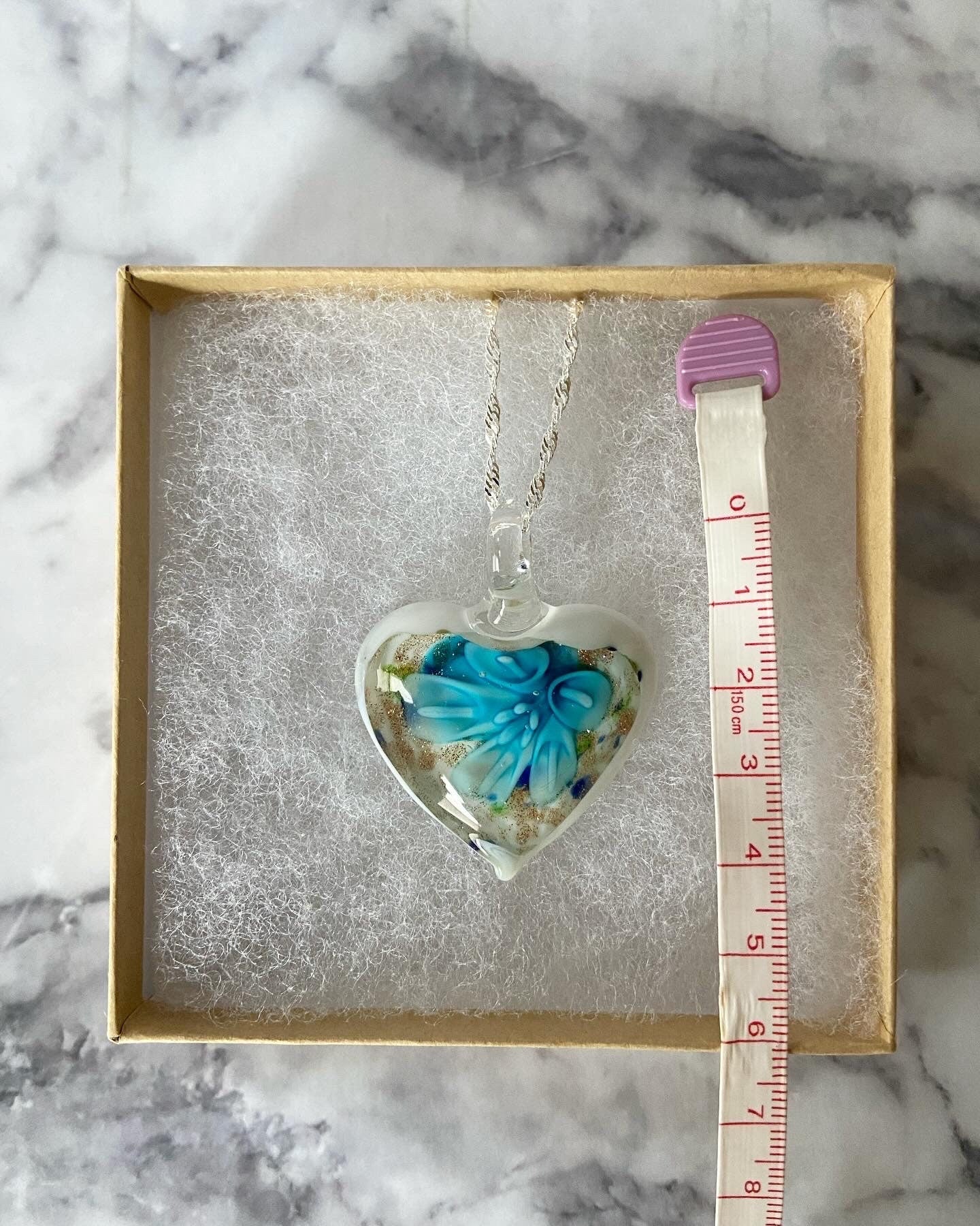 Large light blue calla lily floral with gold glitter on white Murano style heart glass necklace