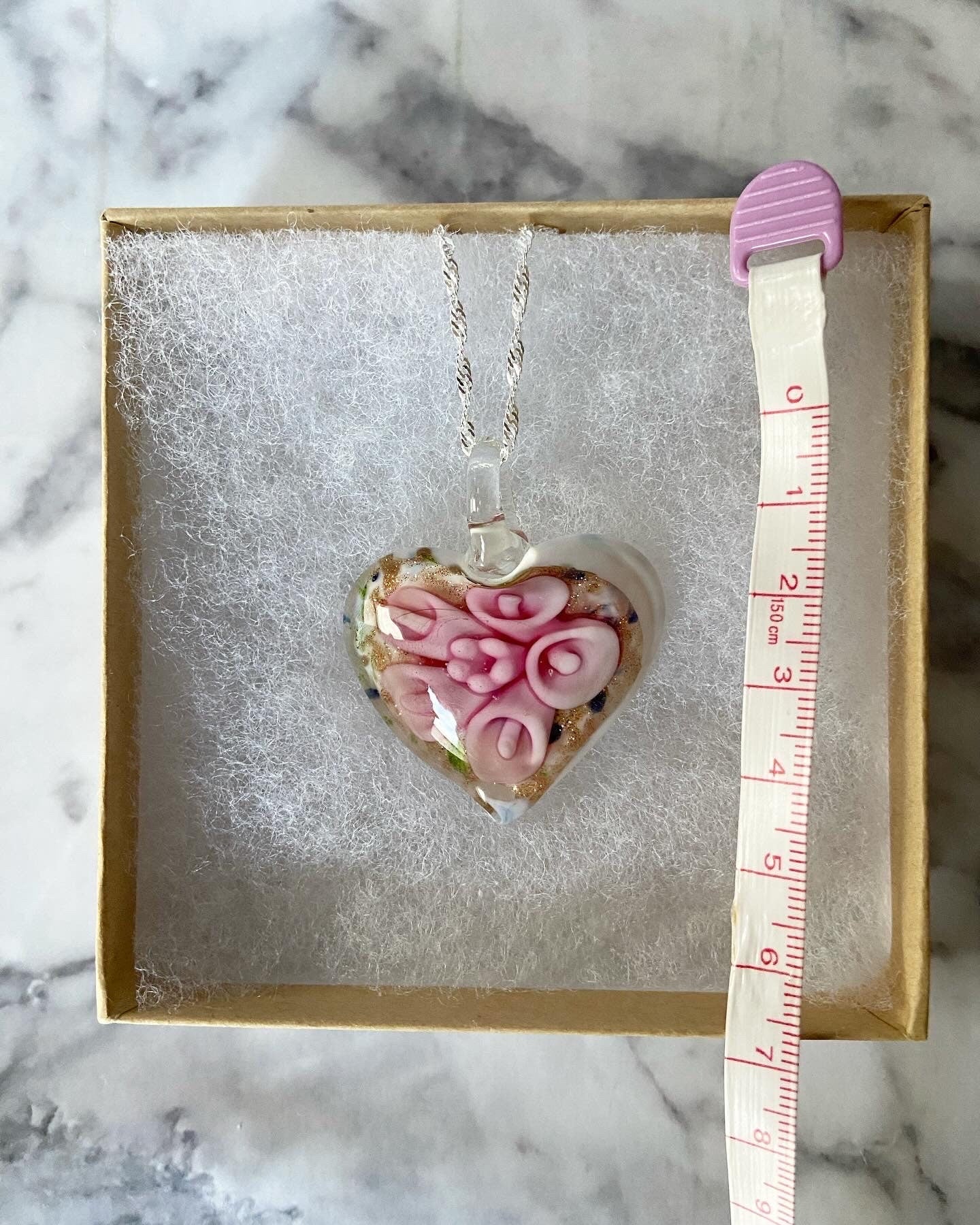 Large light pink calla lily floral with gold glitter on white Murano style heart glass necklace