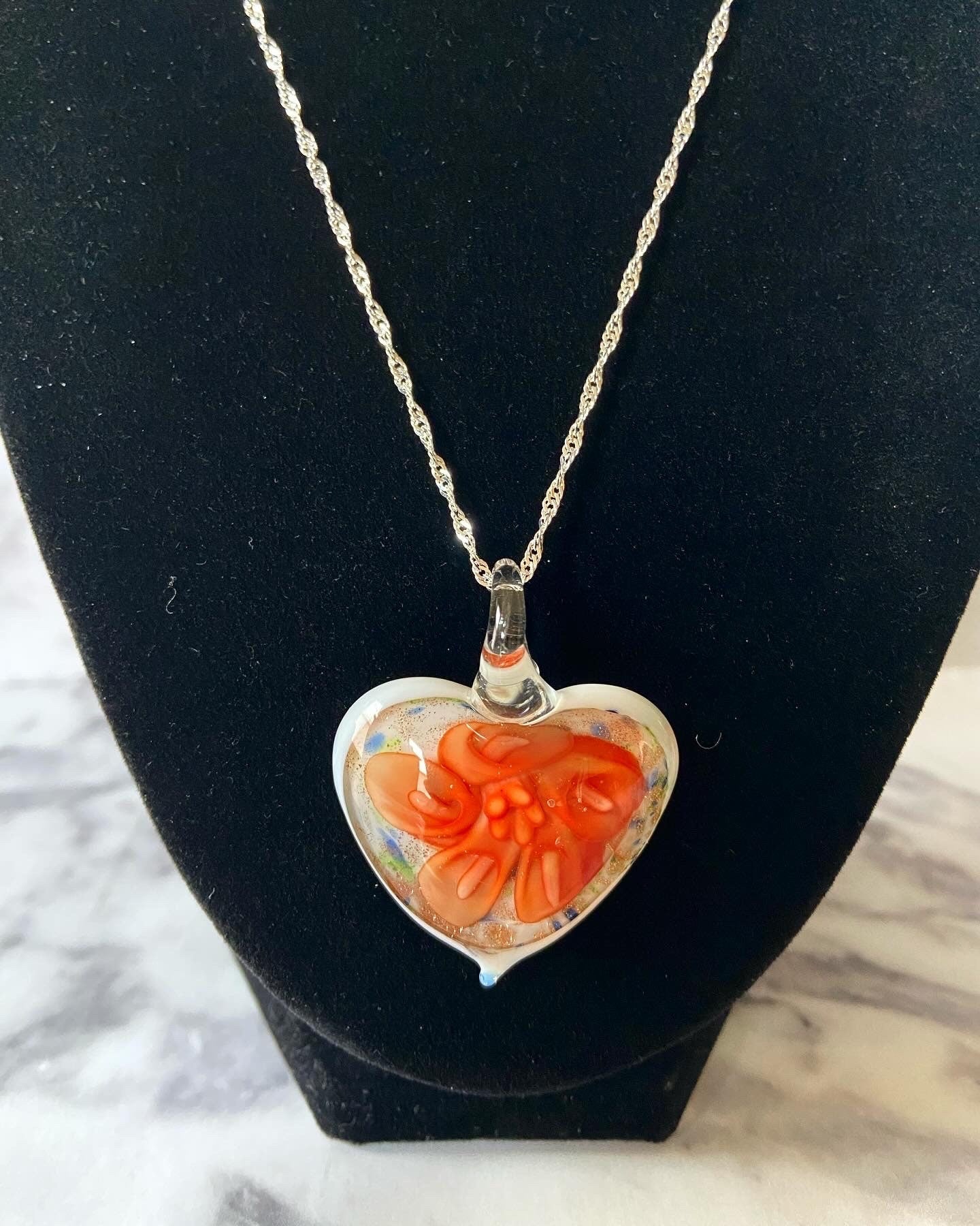 Large orange calla lily floral with gold glitter on white Murano style heart glass necklace