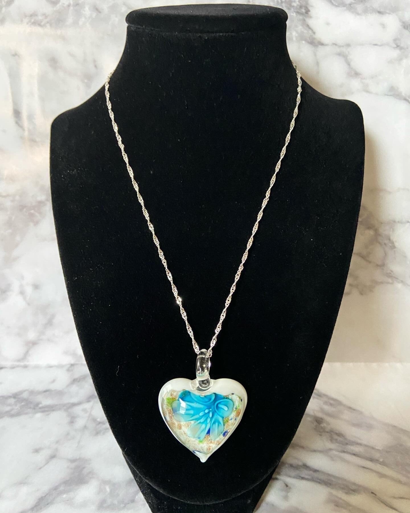 Large light blue calla lily floral with gold glitter on white Murano style heart glass necklace