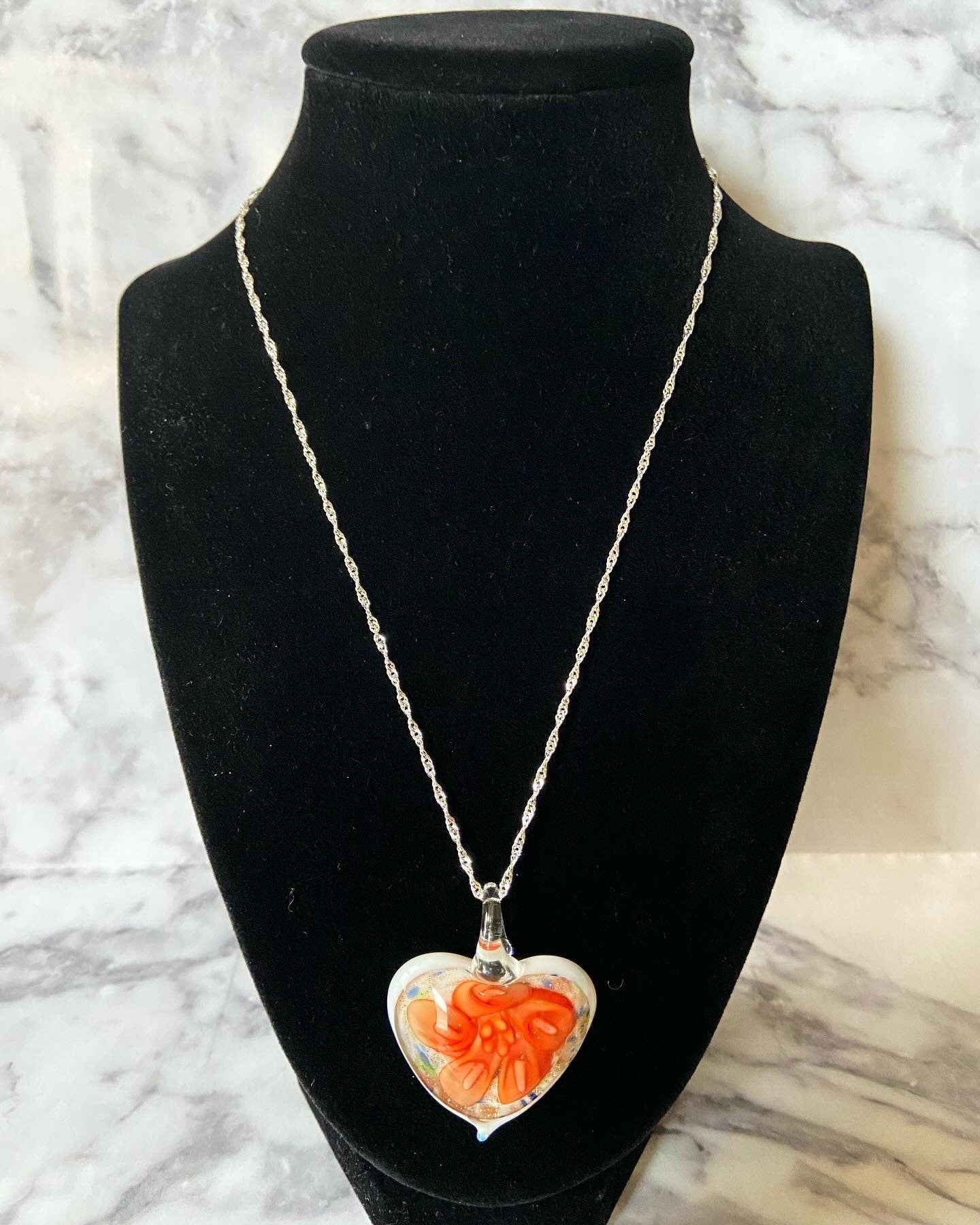 Large orange calla lily floral with gold glitter on white Murano style heart glass necklace