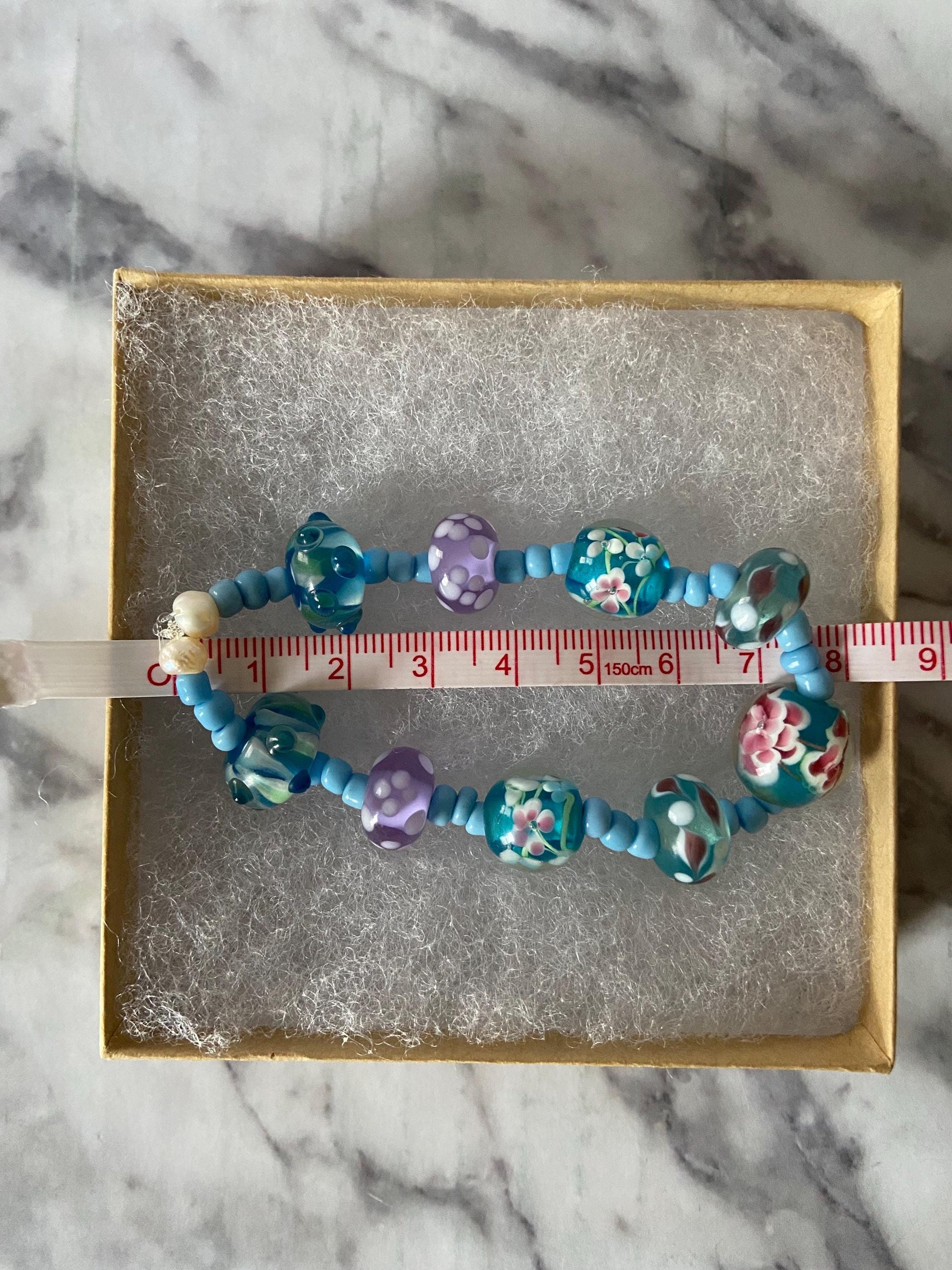 Blue lampwork glass beaded spring flowers stretch bracelet