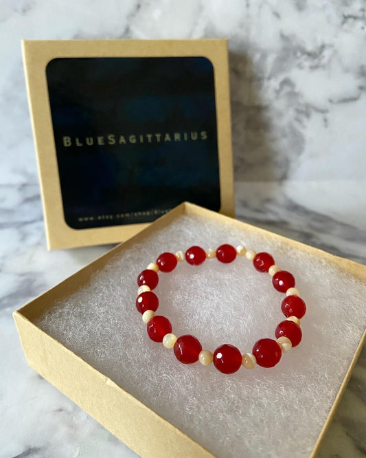 Faceted red jade dyed color enhanced stretch bracelet with mother of pearl shell beads